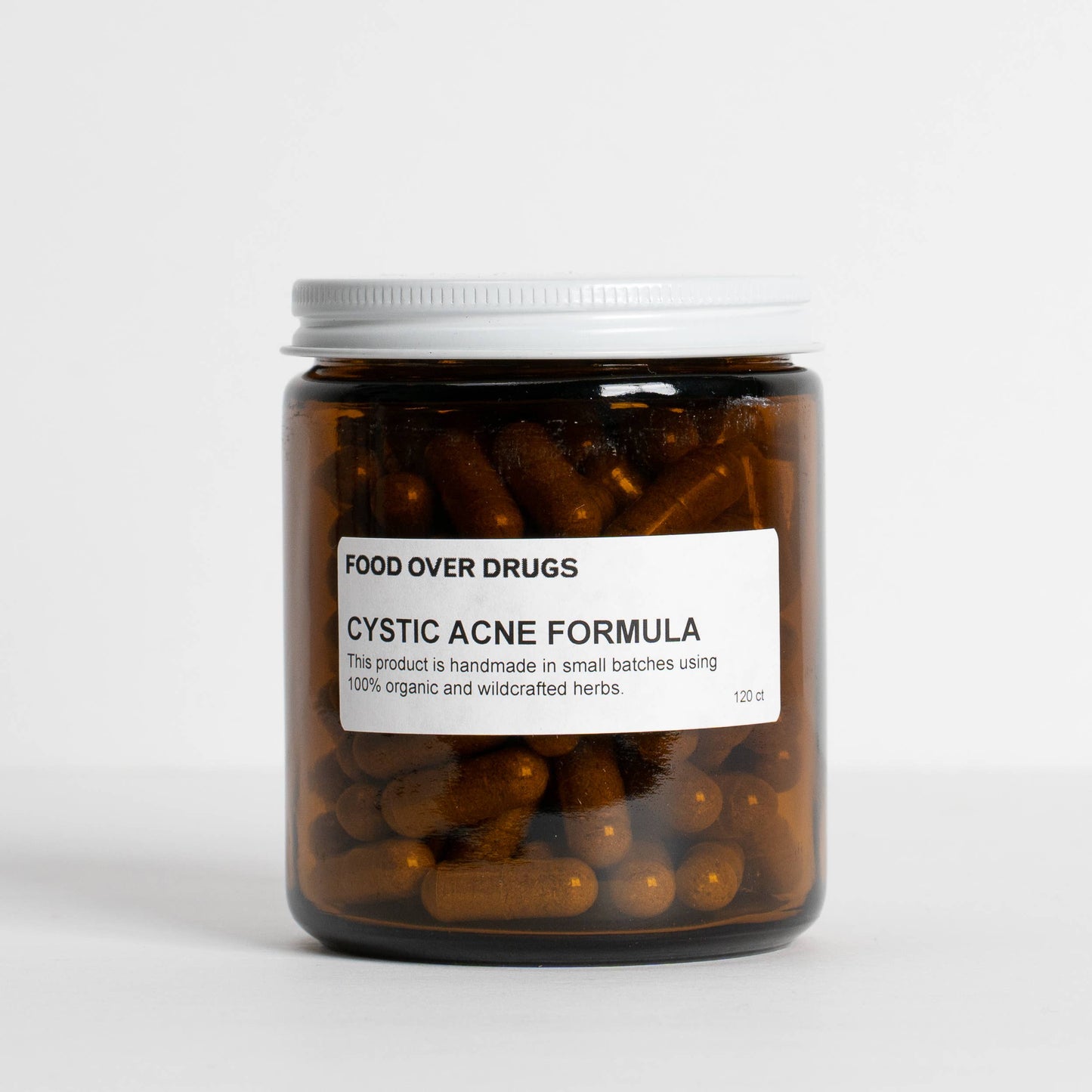 
                  
                    Food Over Drugs Cystic Acne Formula amber jar with the herbal capsules visible through the glass
                  
                