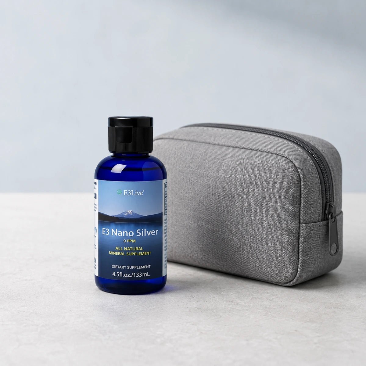 
                  
                    E3 Nano Silver 9 ppm 133 mL bottle next to a grey fabric travel pouch
                  
                