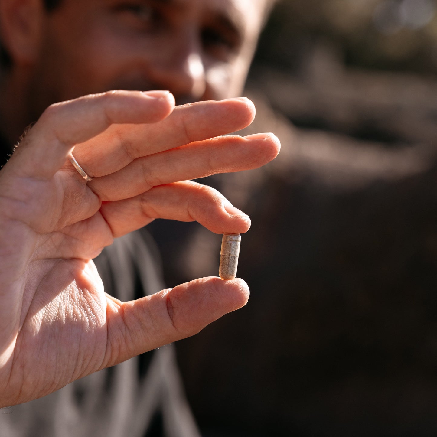 
                  
                    Close up of a single Iconic Iron plant based vege capsule held between finger and thumb
                  
                