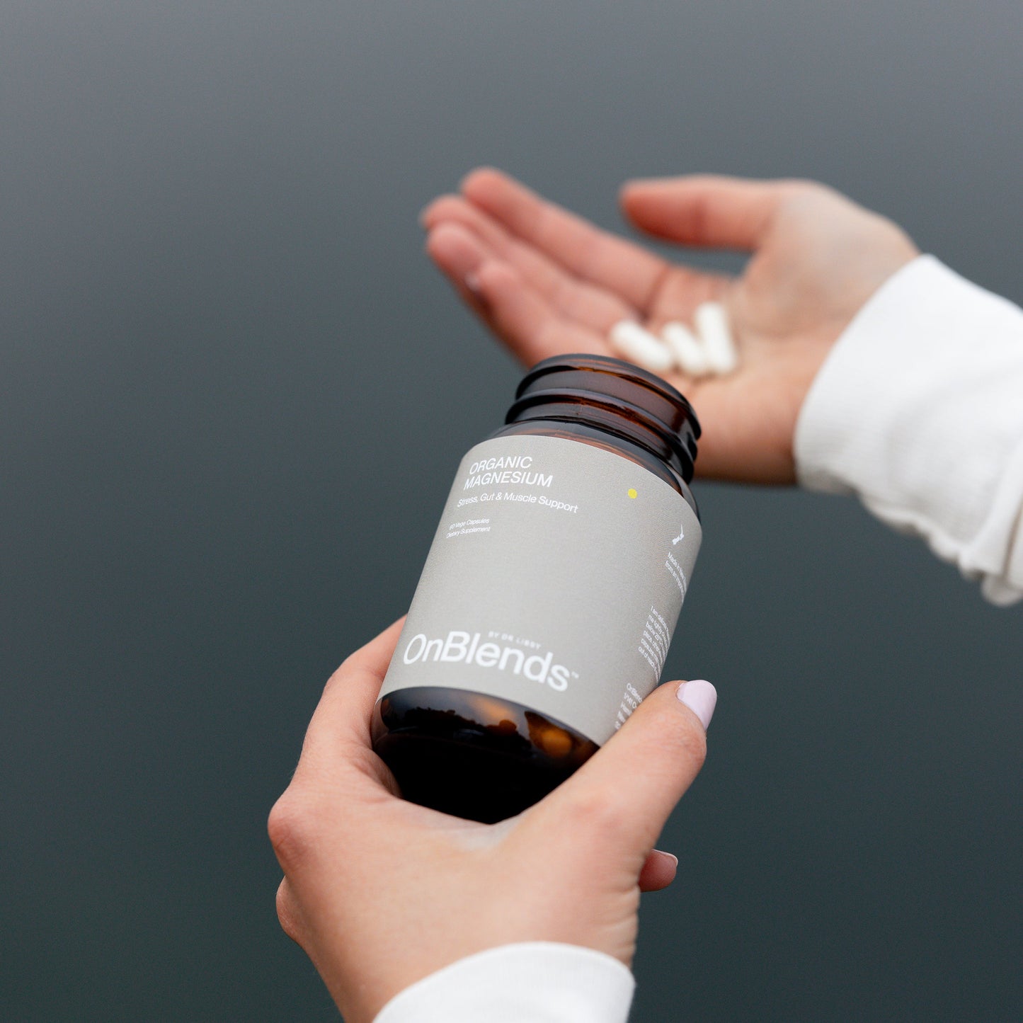 
                  
                    OnBlends Organic Magnesium capsules being tipped from the bottle into an open hand
                  
                