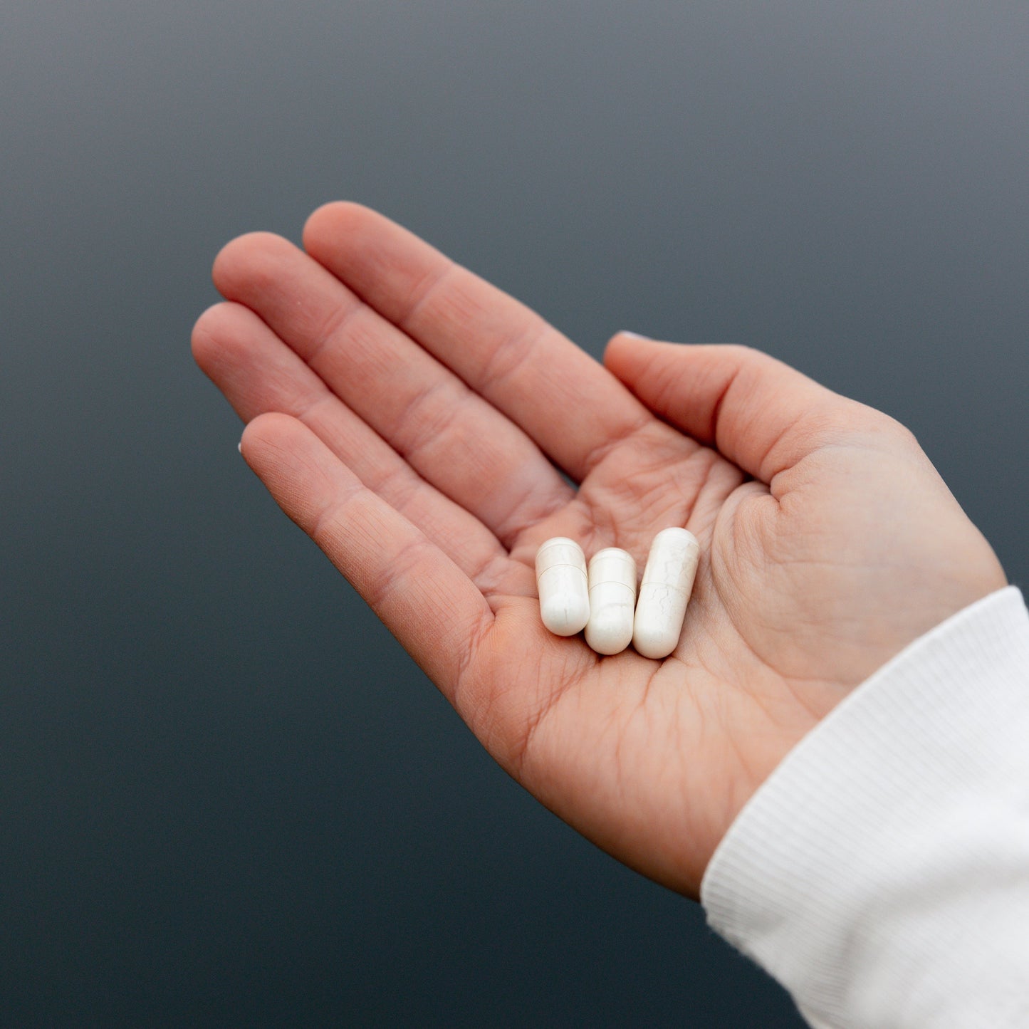 
                  
                    Three OnBlends Organic Magnesium vege capsules resting in an open palm
                  
                